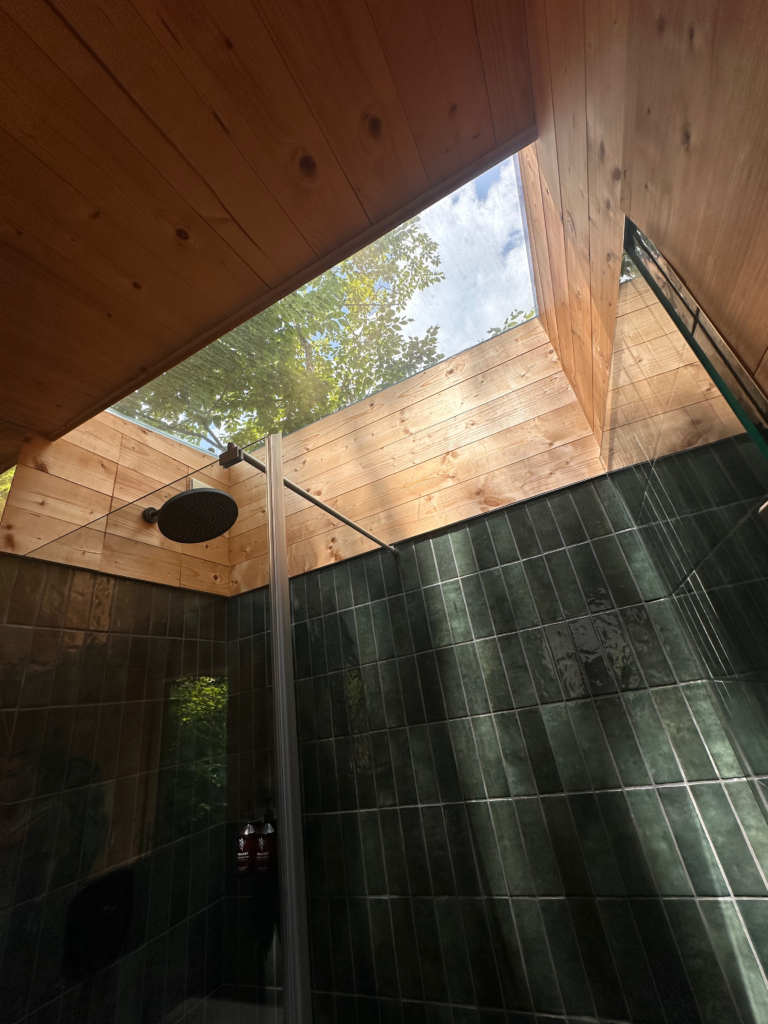 Shower with open ceiling at the Eastwind Hotel Oliverea Valley | One of our favorite Catskills Wedding Venues