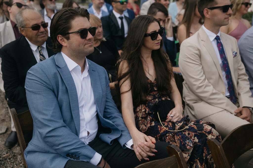 Wedding guests holding hand at a ceremony