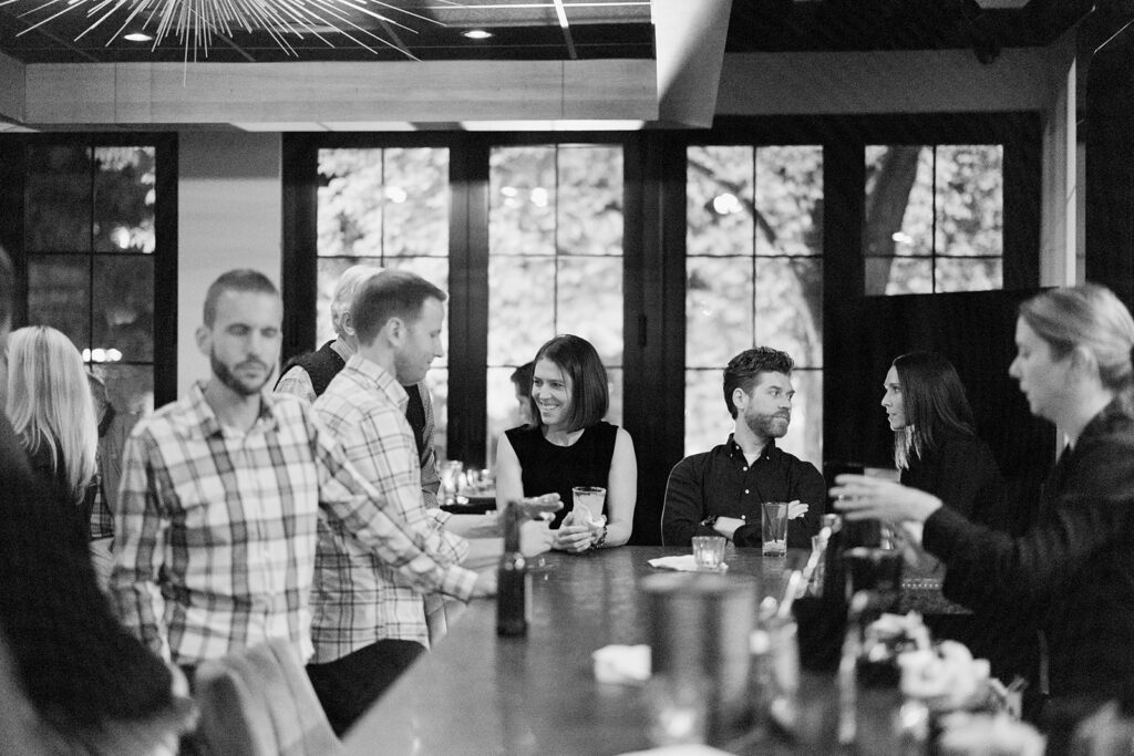 Crowd at the bar enjoying drinks and laughing