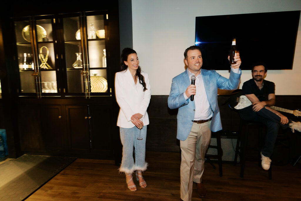 Couple doing a speech at their rehearsal dinner