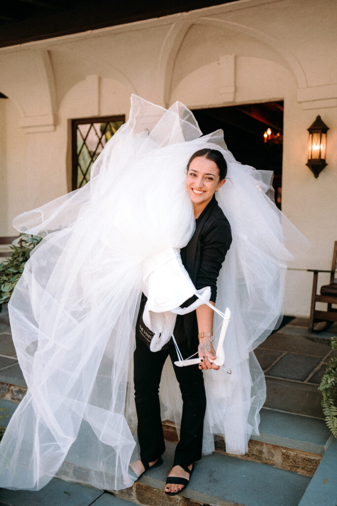 Hudson Valley Wedding Planner Kelly Jeanmaire carrying a dress