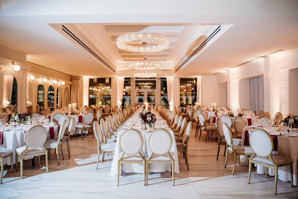 Elegant ballroom reception design with long tables and chandeliers at a luxury New York wedding.
